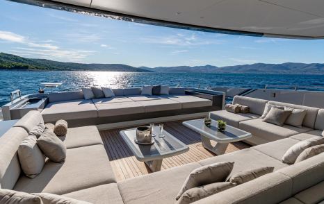 Superyacht Kinda aft deck with beige sunpads and seating