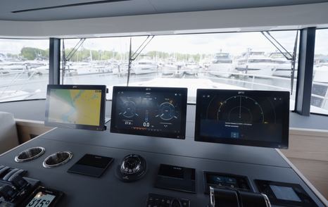 Beneteau Grand Trawler 63 lower helm dashboard with navigation displays and excellent forward visibility