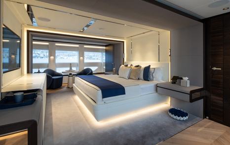 Motor yacht SLP's master cabin with large bed and desk 