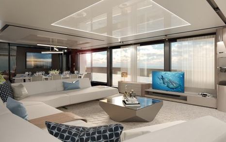 white U-shaped sofa and coffee table face a widescreen TV and full-length windows in the main salon of Sunseeker 100 Yacht