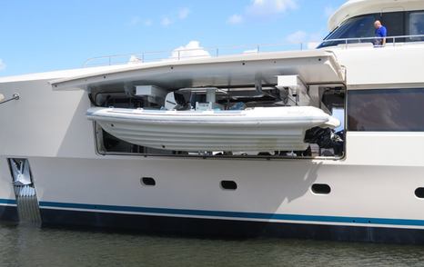 Boat being lowered from tender garage 