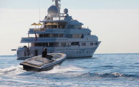 Chase boat on sea with superyacht in background