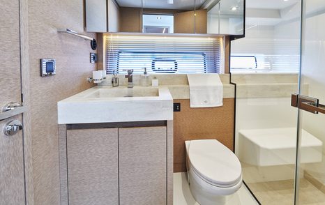 Small but elegant bathroom on yacht, toilet and sink next to each other