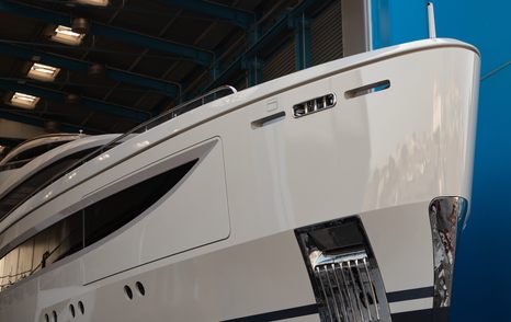 A starboard-side view of Benetti superyacht IRYNA's bow as it emerges from the shed following its completion