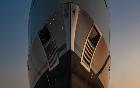 A view from below of Benetti superyacht IRYNA's commanding bow, complete with stainless steel fixtures and anchor pockets