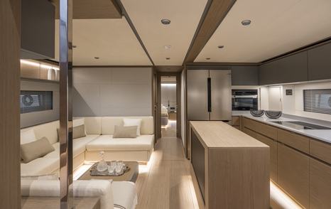 The Pardo GT75 galley and lower salon area features light woods and neutral tones for an airy ambiance 