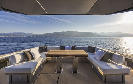 A view looking aft onboard the Pardo GT75, with a U-shaped sofa in the foreground