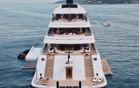 Aft view of megayacht IJE, all aft decks visible, including fold down balconies on both port and starboard sides.