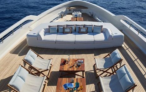 Superyacht Somnium foredeck with grey seating and deck chairs 
