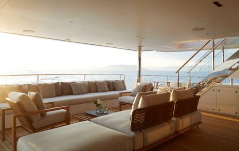 Sofas undercover on Sofas on deck of Benetti Diamond 145 INK superyacht with sunsetting