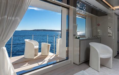 Spacious and minimalist balcony with modular seating on superyacht Amorcito