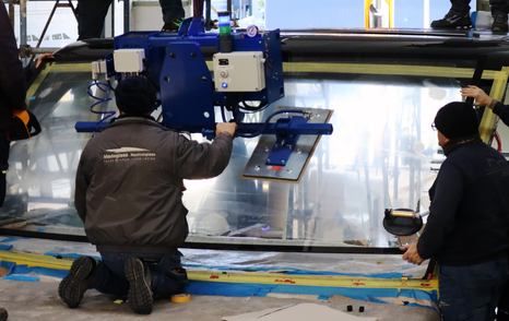 Workers on the foredeck of the First Forte 47 boat under construction 