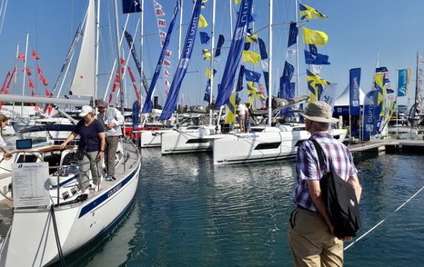 Boats for sale berthed in Mayflower Park decorated with flags