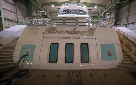 Lurssen 117m Superyacht Boardwalk stern with nameplate and dual staircase in shipyard