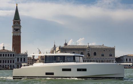 A motor yacht for sale cruising by the Venice Arsenale