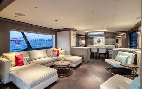 Motor Yacht Saint main saloon with large windows, neutral furnishings and open-plan dining area