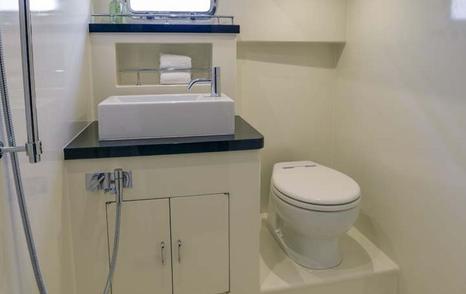 Small toilet on yacht. Toilet next to sink