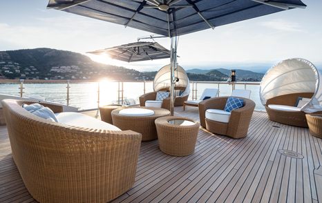 Wicker furniture seating area on superyacht Vision