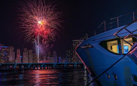 Fireworks above Dubai Harbour with motor yacht in the foreground