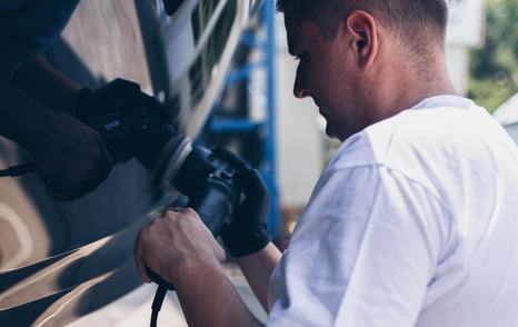 Person polishing the yacht hull