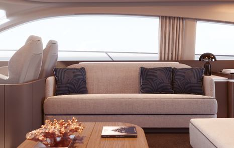 Comfortable sofa with table in front and windo behind on Azimut 53