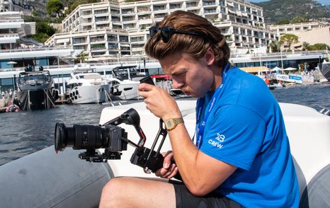 man filming on boat