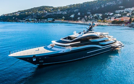 Oceanco yacht DAR aerial view over port bow and along side profile, still waters, bright day, land in background