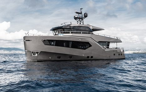 ROCK X by Evadne Yachts shown from water level towards port bow and port side profile, on bright but cloudy day in moderate sea