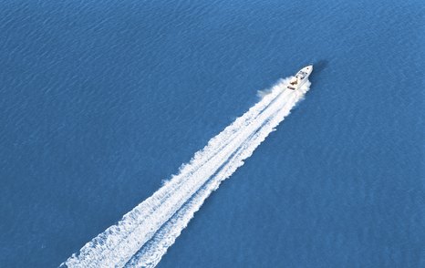 Motor yacht speeding across the water