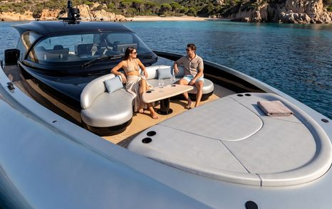 Rendering of couple relaxing on ICONA 70 motor yacht foredeck 