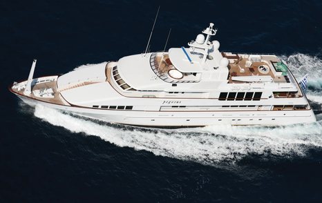 Feadship yacht PEGASUS shown in aerial running shot over port side profile, moving at speed in calm waters