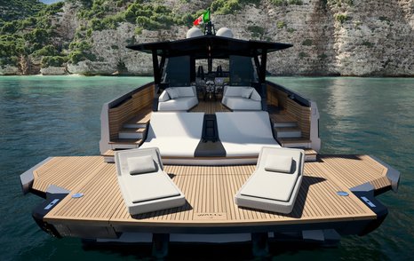 Extendable swim platform onboard Wally WHY100. Yacht in the sea facing large cliffs.