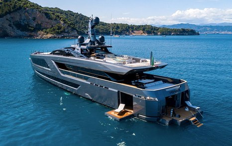 Aft view of superyacht PANAM, transom and port side balcony folded down with sun loungers on top. 