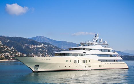 Superyacht EMINENCE at a stand still in a flat, bright blue sea