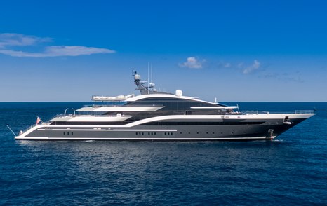 A starboard-side view of Oceanco superyacht DAR at anchor in a calm blue sea