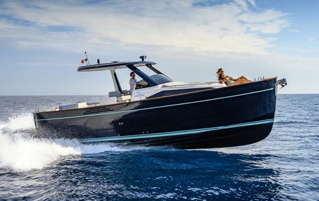 Apreamare Gozzo 35 boat under way with woman on bow 