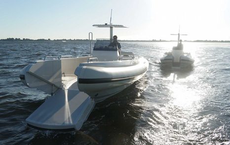 Stationary beachlander tender in twilight on still water