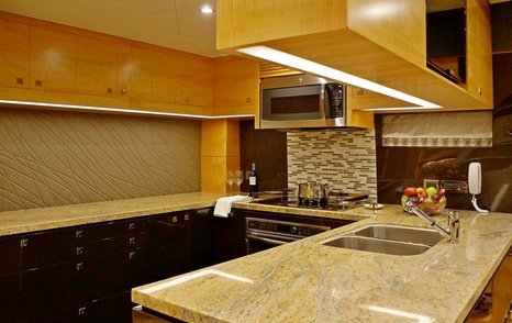 Galley on yacht with marble  top and wooden detailing