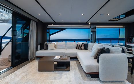 Ferretti 800 motor yacht saloon with L-shaped white sofa 
