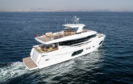 Stern view of Numarine 22XP underway, surrounded by sea with land in far distance.