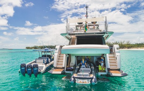 RIB tender being pulled on board yacht to go in tender garage