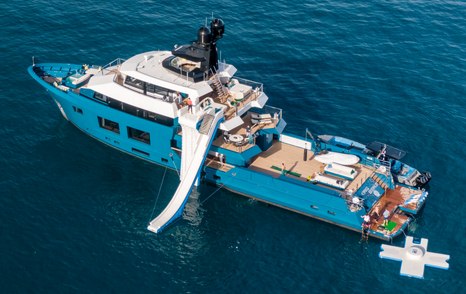 Explorer yacht KING BENJI at anchor with its inflatable slide running down the port-side 