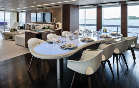 Superyacht ELA's dining area features free-standing furniture. 