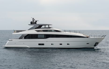 A starboard-side view of the Sanlorenzo SL86A sporting a white hull and extensive black glazing, floating in a calm grey sea