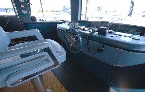 Benetti Oasis 34M wheelhouse showing the central helm station, captain's chair and navigation console.