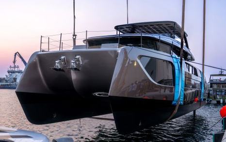 Sunreef Ultima 88 suspended above water at launch 