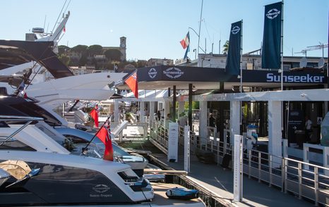 Cannes Yachting Festival 2024 Opening Day sunseeker stand with sunseeker boats moored to pontoon, blue sky