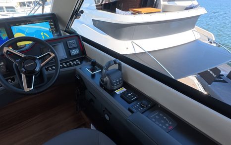 Maritimo M50 helm console with navigation screens, throttle controls and side window view