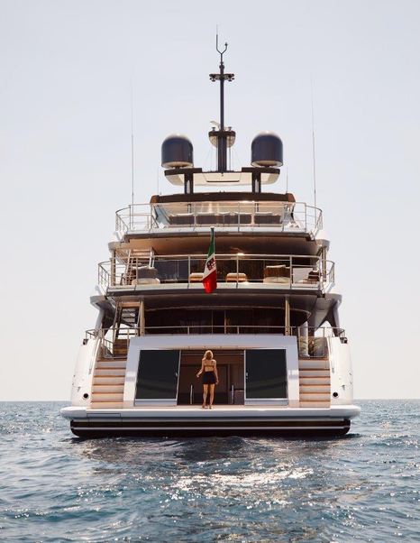 Back of Lounge are on Benetti Diamond 145 INK superyacht with woman standing on deck