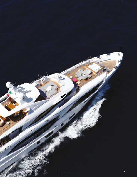 Aerial view looking down on a superyacht bow underway at sea